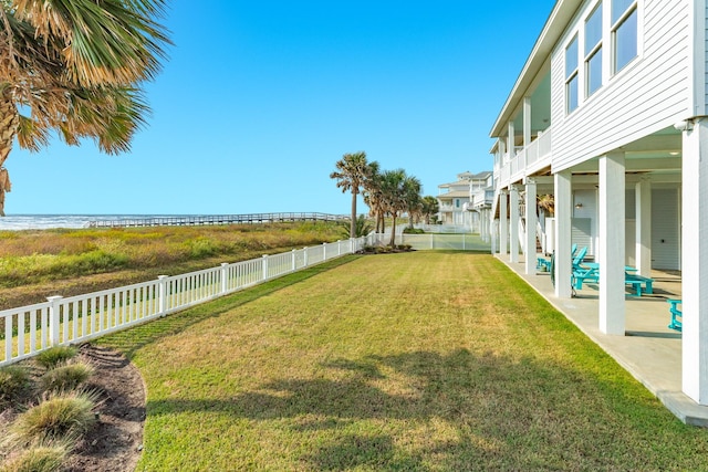 view of yard with a water view and a patio area