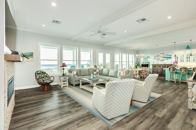 living room featuring beam ceiling, ornamental molding, dark hardwood / wood-style floors, and a healthy amount of sunlight