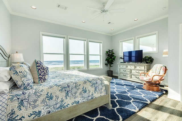 bedroom featuring crown molding, ceiling fan, and light hardwood / wood-style floors