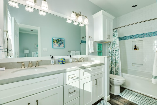 full bathroom featuring vanity, hardwood / wood-style flooring, toilet, and shower / bath combo with shower curtain