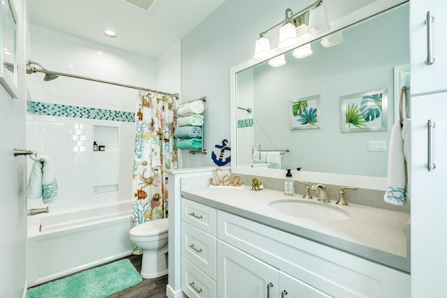 full bathroom featuring hardwood / wood-style flooring, vanity, toilet, and shower / tub combo