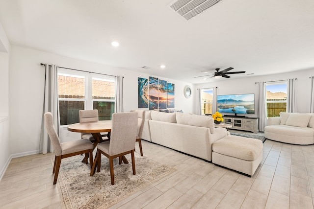 dining space featuring ceiling fan and light wood-type flooring