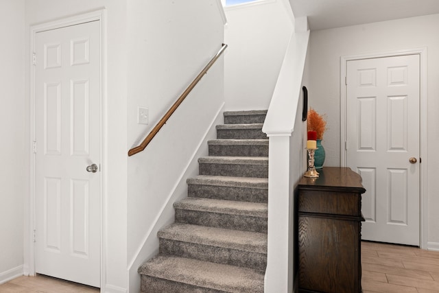 staircase with hardwood / wood-style floors