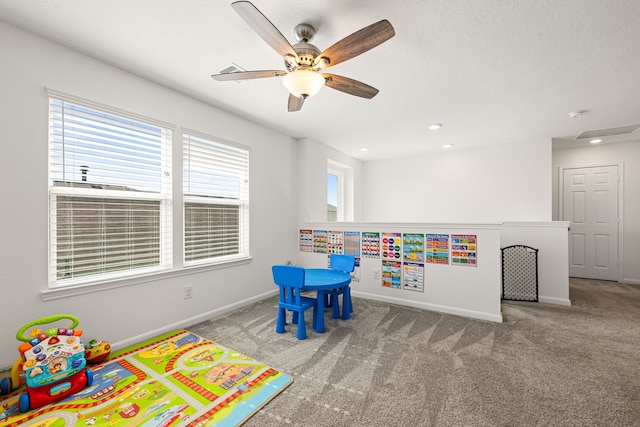 recreation room with carpet and ceiling fan