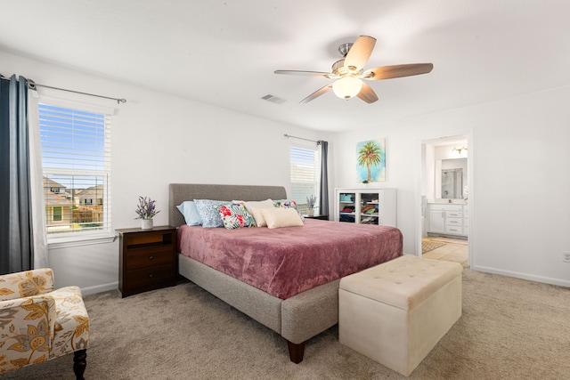 carpeted bedroom featuring connected bathroom and ceiling fan