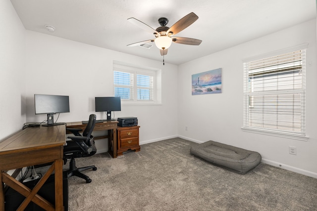 carpeted office space with ceiling fan