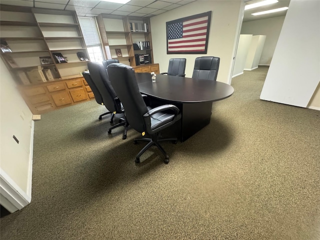 carpeted office featuring a paneled ceiling