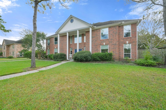 greek revival inspired property with a front yard