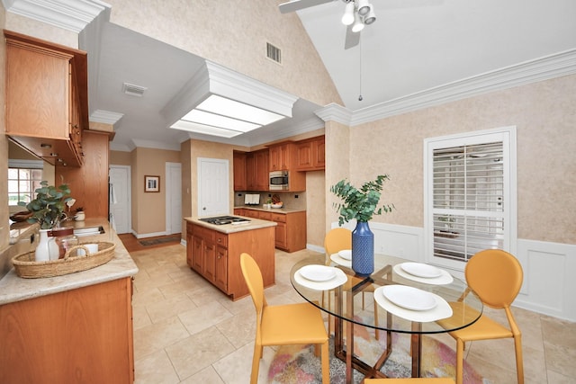 kitchen with stainless steel microwave, lofted ceiling, crown molding, ceiling fan, and black gas stovetop