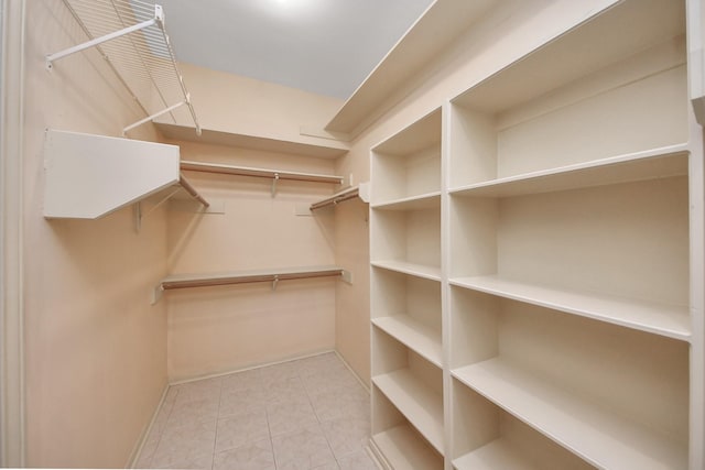 spacious closet featuring light tile patterned floors