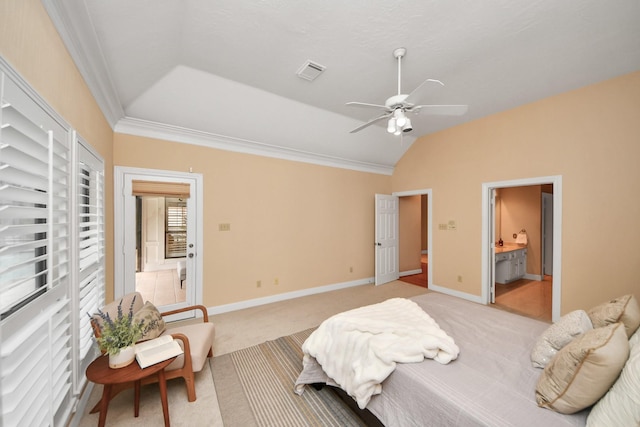 carpeted bedroom featuring ornamental molding, lofted ceiling, ceiling fan, and ensuite bath