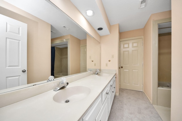 bathroom with vanity and a bath