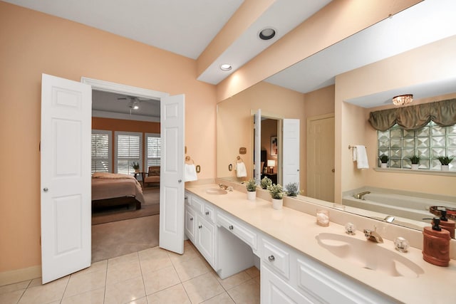 bathroom with tile patterned flooring, vanity, and a washtub