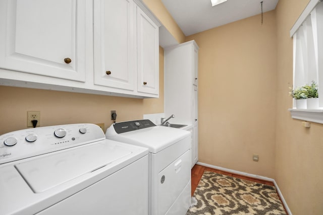 laundry room with cabinets, independent washer and dryer, sink, and hardwood / wood-style floors