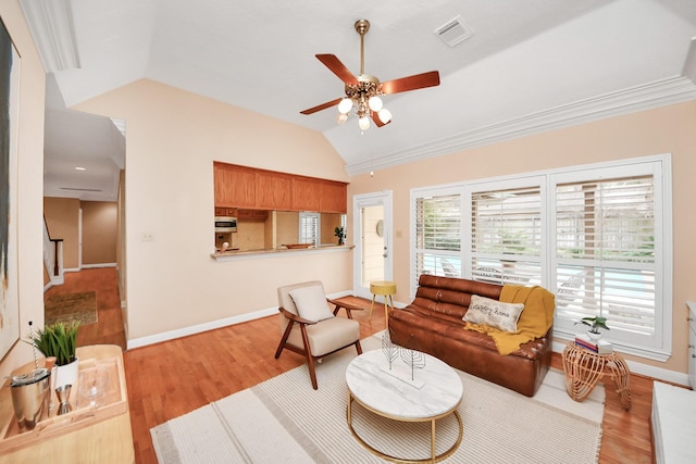 living room featuring ceiling fan, lofted ceiling, and light wood-type flooring