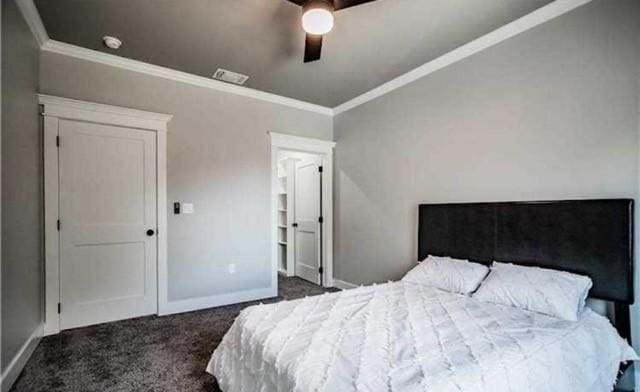 carpeted bedroom featuring crown molding and ceiling fan