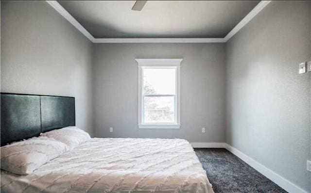 carpeted bedroom with crown molding and ceiling fan