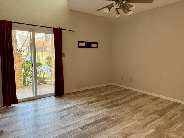 empty room with ceiling fan, plenty of natural light, and light wood-type flooring