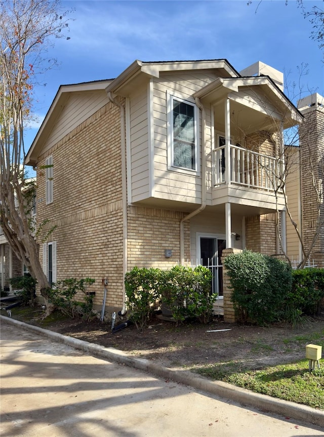 view of side of home featuring a balcony