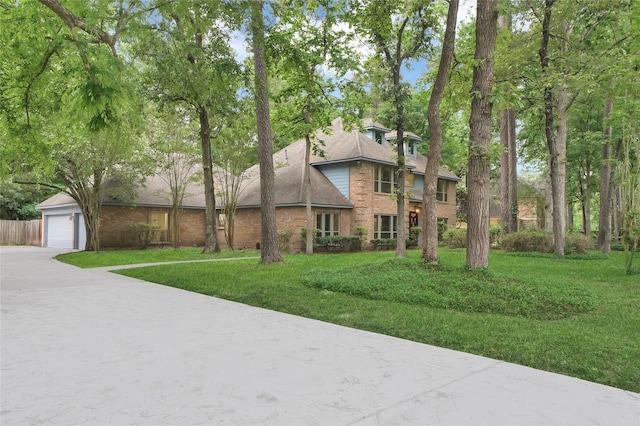 view of front of home featuring a garage and a front yard