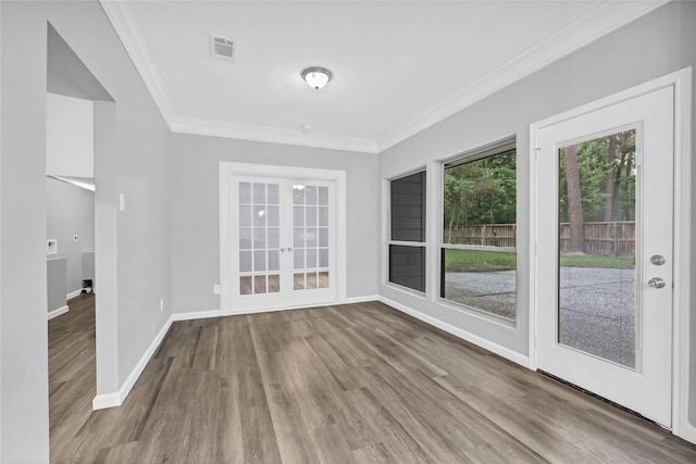 interior space with light hardwood / wood-style flooring, ornamental molding, and french doors