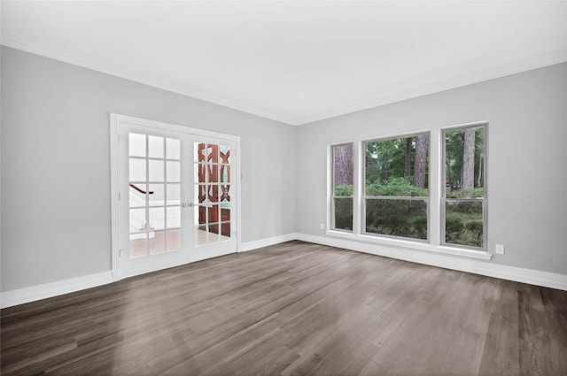 unfurnished room featuring french doors, dark hardwood / wood-style flooring, and crown molding