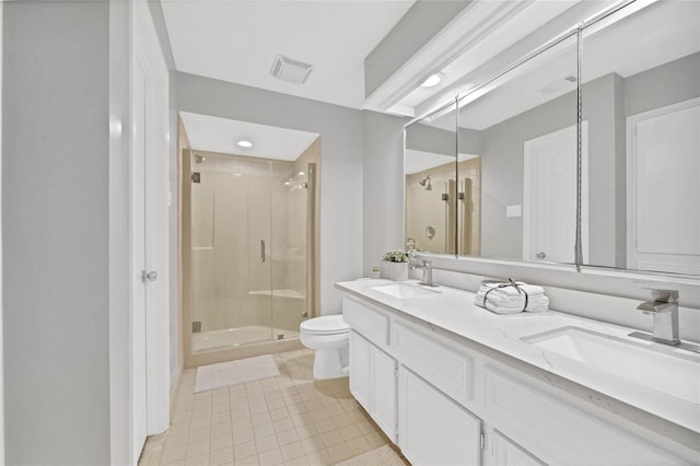 bathroom featuring vanity, tile patterned floors, toilet, and walk in shower