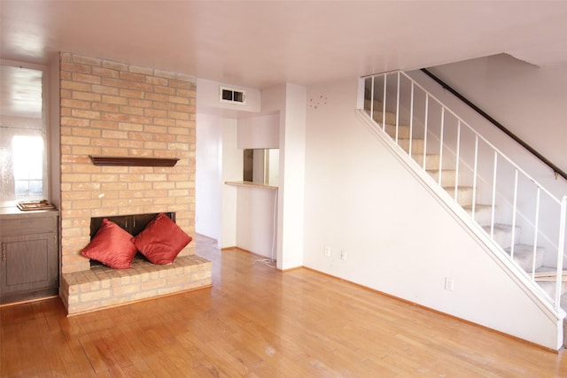 unfurnished living room featuring hardwood / wood-style flooring