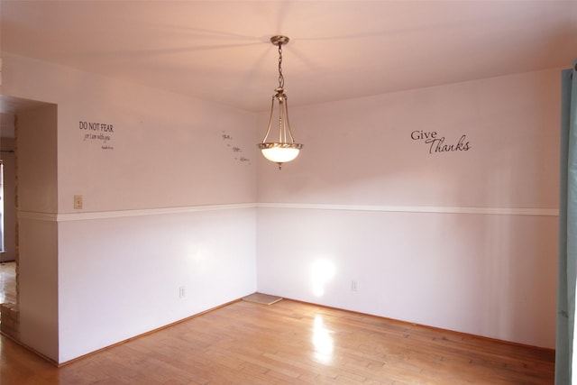 spare room featuring wood-type flooring