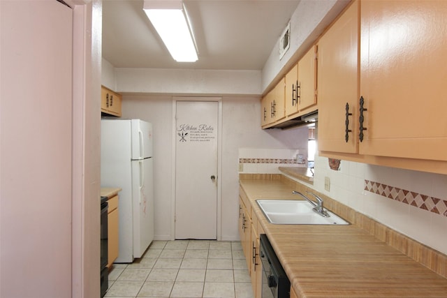 kitchen featuring dishwasher, sink, backsplash, white fridge, and light tile patterned floors