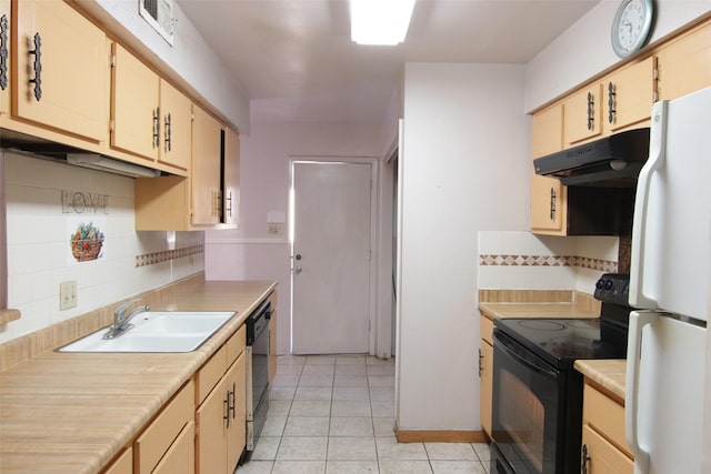 kitchen featuring light brown cabinetry, sink, light tile patterned floors, decorative backsplash, and black appliances