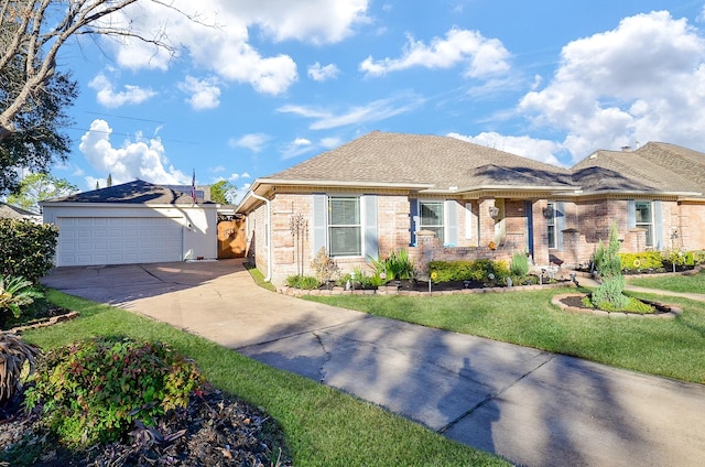 view of front of home with a garage and a front lawn