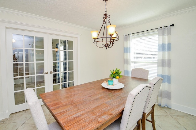 tiled dining room with a notable chandelier, crown molding, french doors, and a textured ceiling