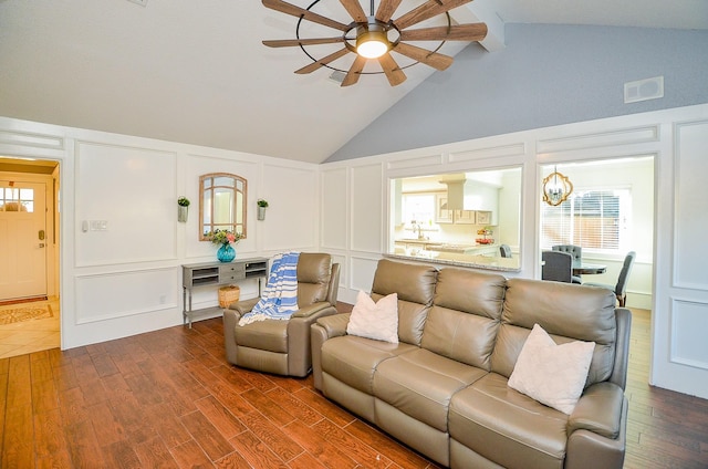 living room featuring lofted ceiling, hardwood / wood-style flooring, and ceiling fan