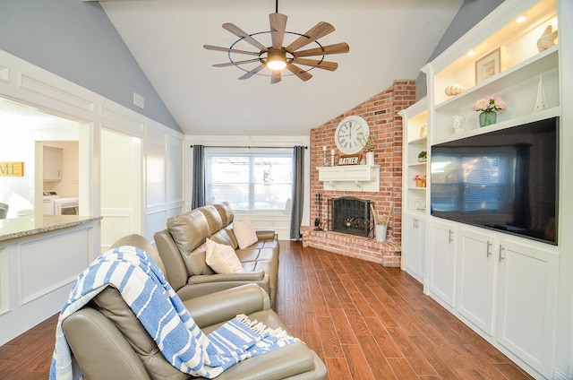 living room featuring lofted ceiling, built in features, ceiling fan, hardwood / wood-style floors, and a fireplace