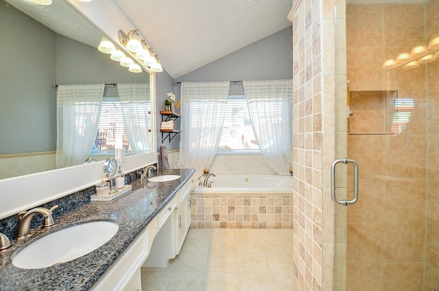 bathroom with independent shower and bath, lofted ceiling, vanity, tile patterned floors, and a textured ceiling