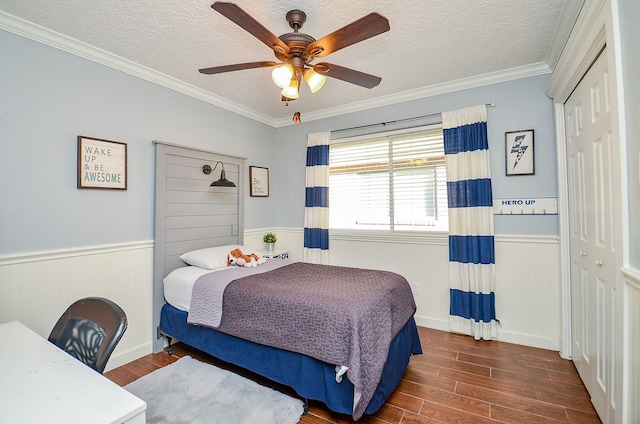 bedroom featuring crown molding, dark wood-type flooring, a closet, and a textured ceiling