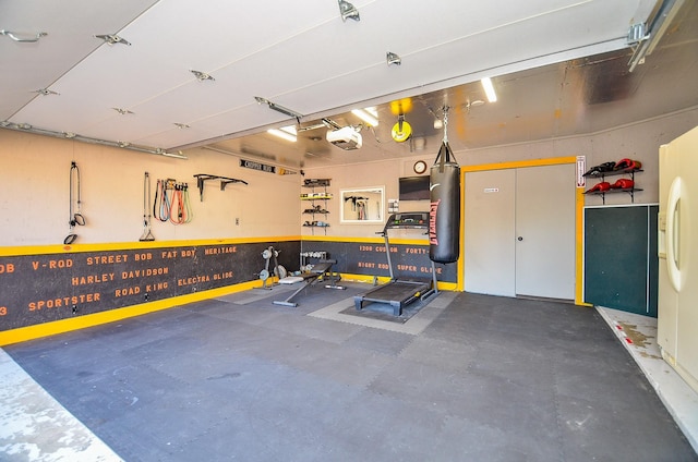 garage featuring a garage door opener and white refrigerator