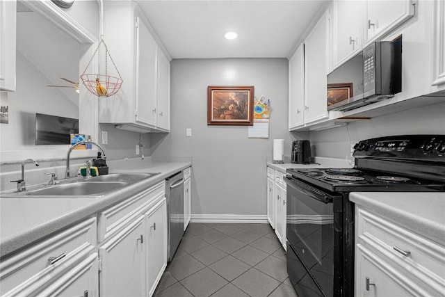 kitchen with white cabinetry, sink, dark tile patterned flooring, and black appliances