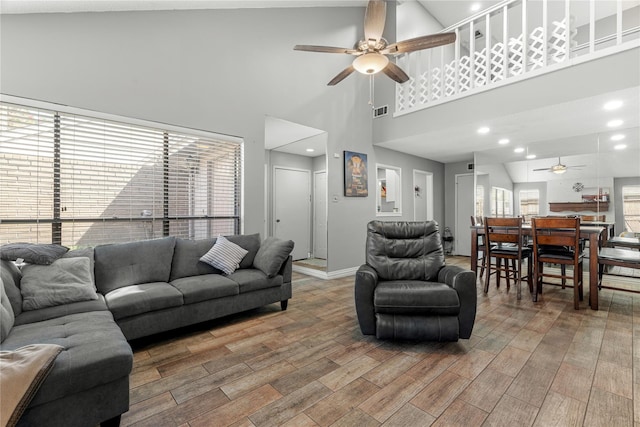 living room with hardwood / wood-style flooring and ceiling fan