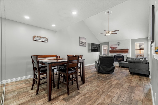 dining room with vaulted ceiling, ceiling fan, and hardwood / wood-style floors