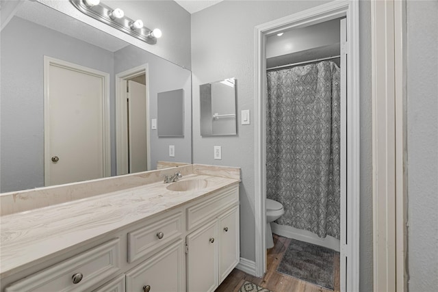 bathroom featuring a shower with curtain, vanity, toilet, and hardwood / wood-style floors