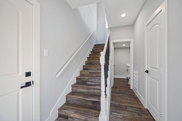 staircase with wood-type flooring