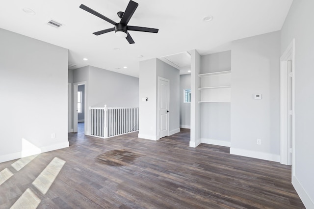 unfurnished living room with dark wood-type flooring and ceiling fan