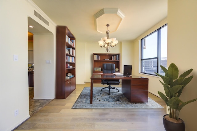 home office with crown molding, an inviting chandelier, and light hardwood / wood-style flooring