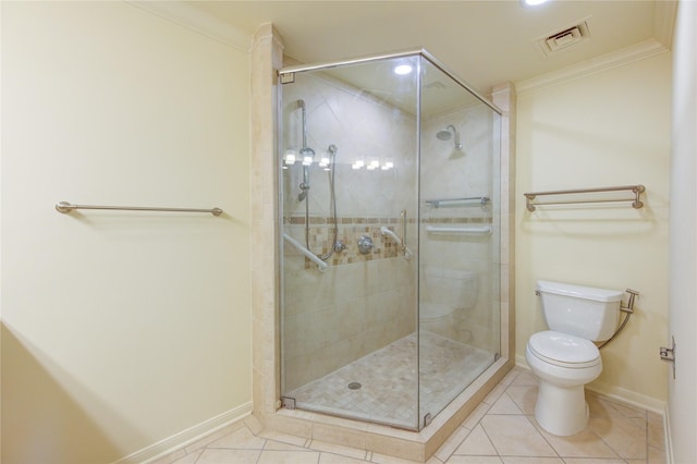 bathroom with ornamental molding, toilet, and tile patterned flooring