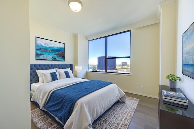 bedroom featuring crown molding and dark hardwood / wood-style flooring