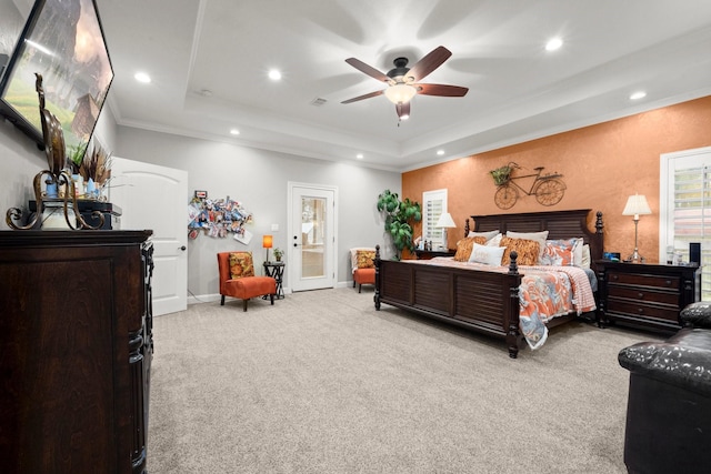 carpeted bedroom with crown molding, a raised ceiling, and ceiling fan