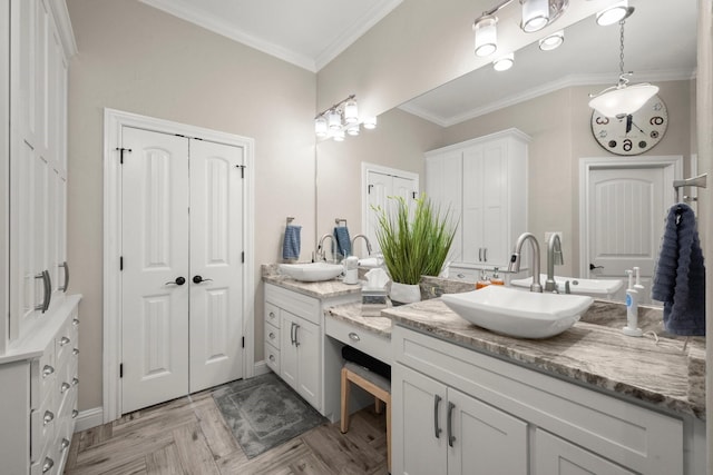 bathroom with parquet floors, ornamental molding, and vanity