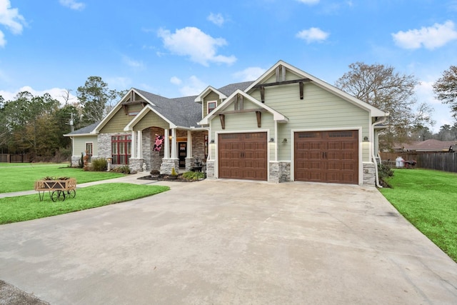 craftsman inspired home with a garage and a front yard